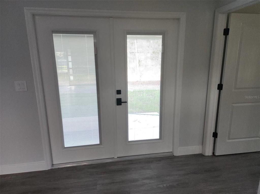 1111 Dagmar Avenue Spring Hill, FL 34606 - Photo 17 of 27 a view of an empty room with wooden floor and a window