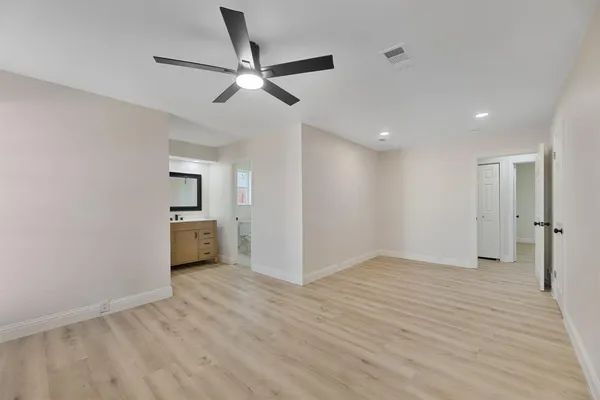 a view of a big room with wooden floor closet and windows