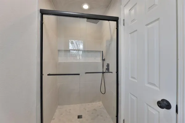 a bathroom with a glass shower door