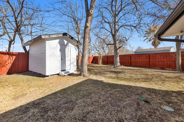 a view of yard covered with snow in front of house