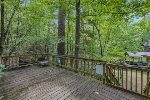 a view of balcony with wooden floor and outdoor seating