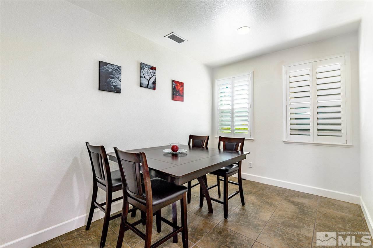 11215 Parma Way Reno, NV 89521 - Photo 14 of 22 a view of a dining room with furniture and a window