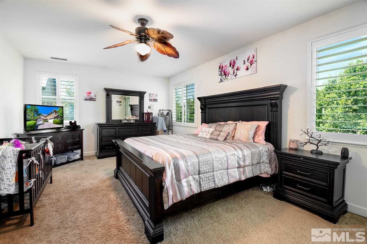11215 Parma Way Reno, NV 89521 - Photo 15 of 22 a bed room with a bed and a tv