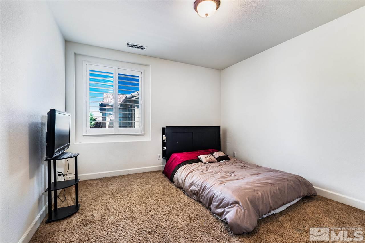 11215 Parma Way Reno, NV 89521 - Photo 20 of 22 a bed sitting in a bedroom next to a window