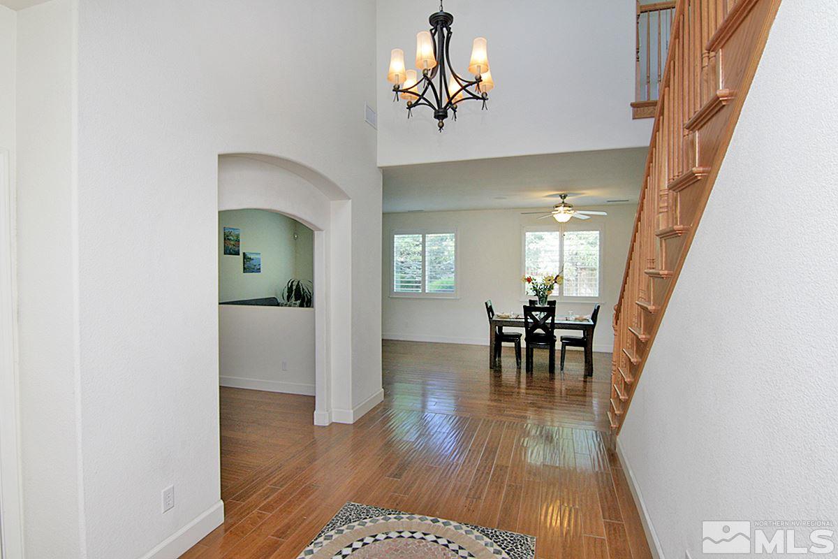 11215 Parma Way Reno, NV 89521 - Photo 3 of 22 a view of a dining room with furniture and a chandelier