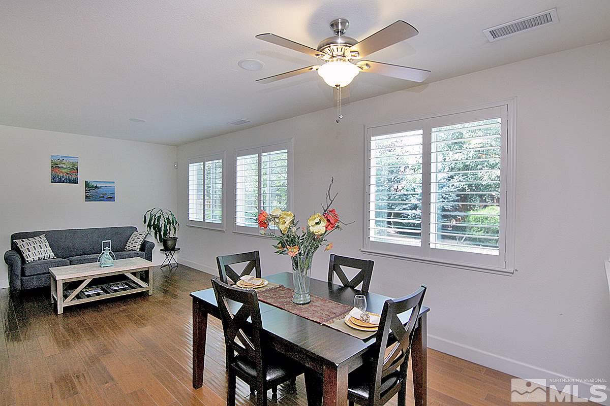 11215 Parma Way Reno, NV 89521 - Photo 5 of 22 a view of a dining room with furniture window and wooden floor