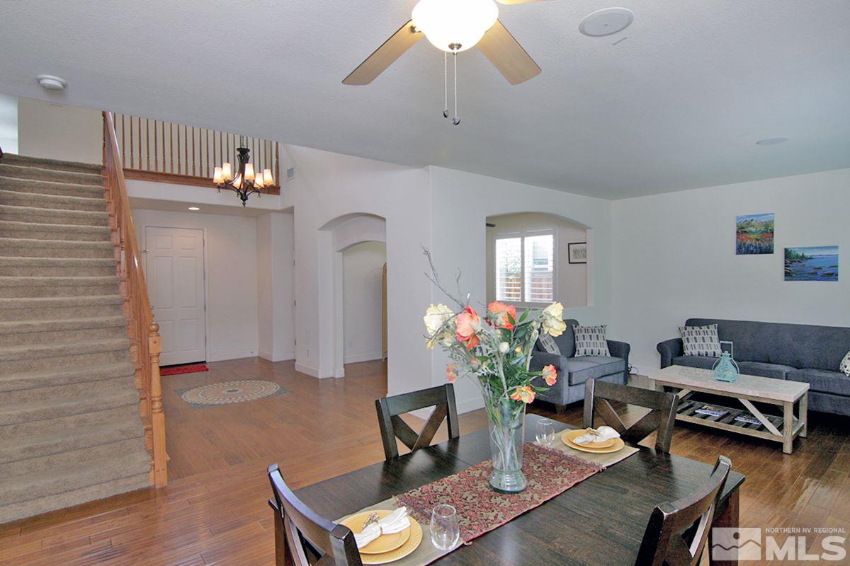 11215 Parma Way Reno, NV 89521 - Photo 6 of 22 a living room with furniture and a chandelier