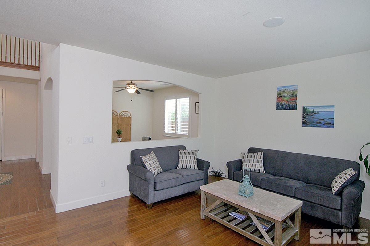 11215 Parma Way Reno, NV 89521 - Photo 7 of 22 a living room with furniture and a wooden floor