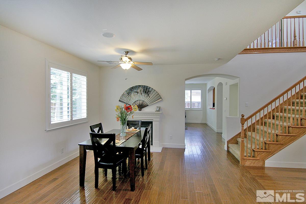 11215 Parma Way Reno, NV 89521 - Photo 8 of 22 a view of a dining room with furniture and wooden floor