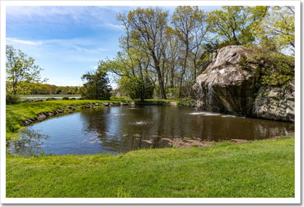 67 Border Street Scituate, MA 02066 - Photo 4 of 30 a view of a lake with a yard and large trees