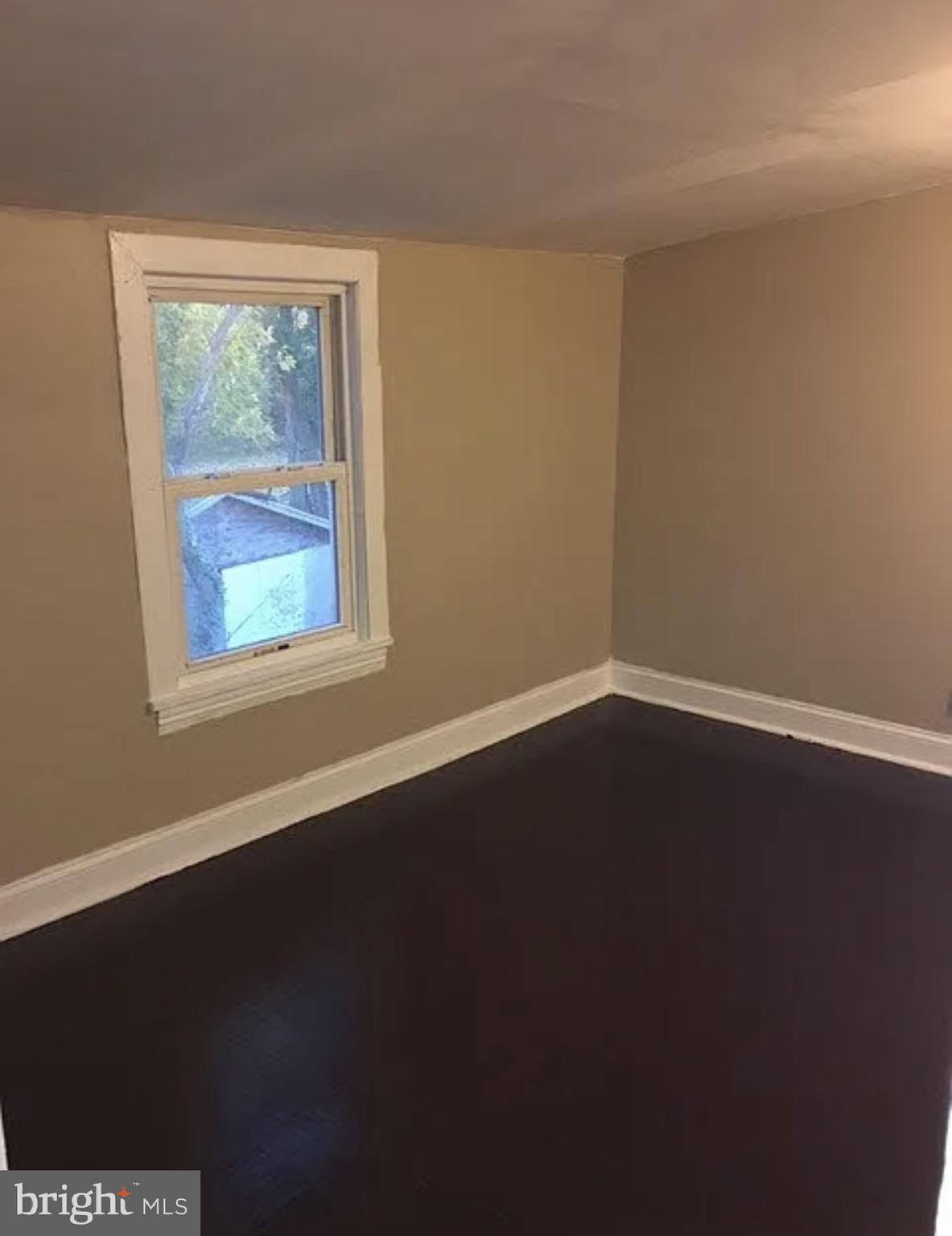 37 Olive Street Salem, NJ 08079 - Photo 11 of 19 a view of an empty room with wooden floor and a window