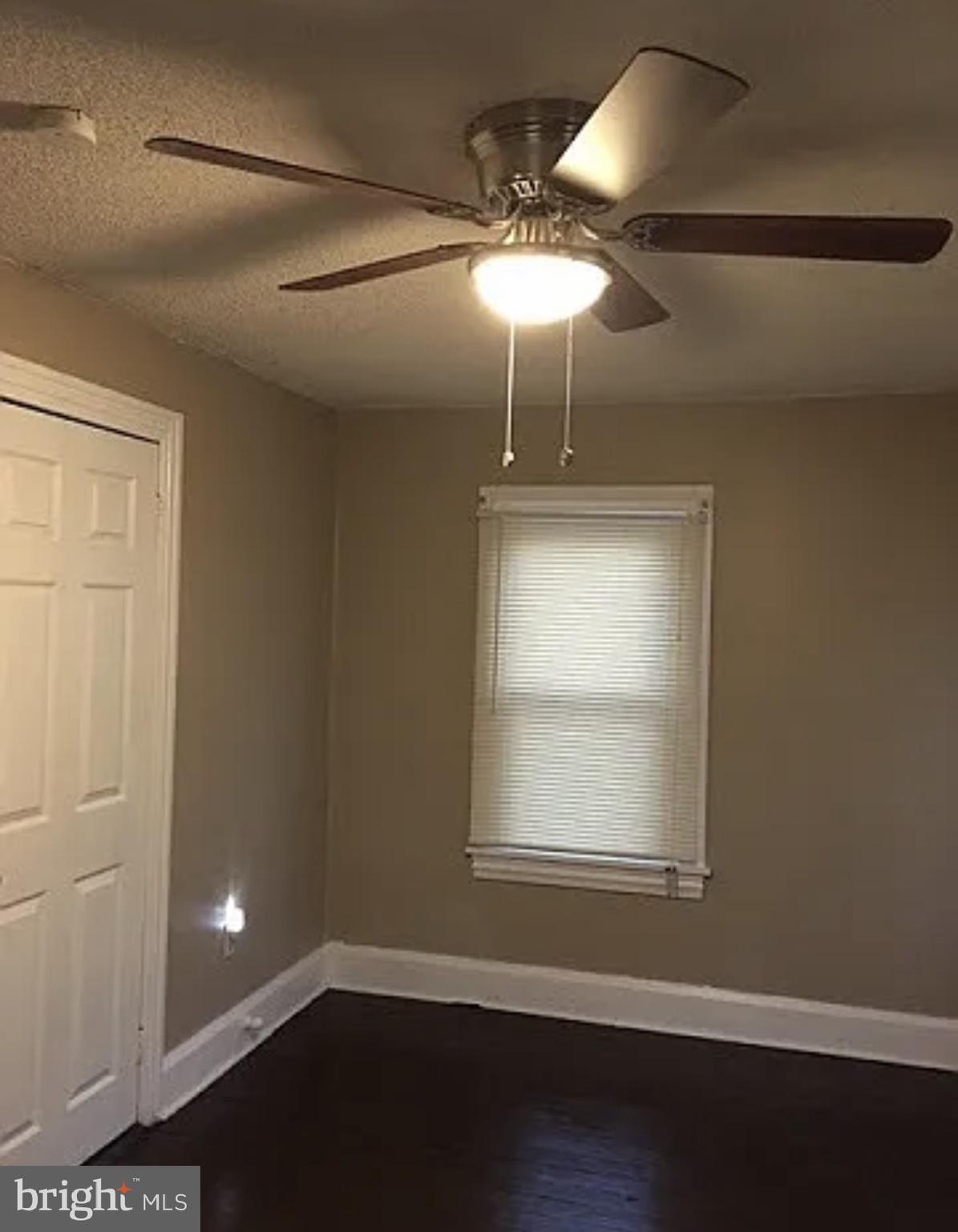 37 Olive Street Salem, NJ 08079 - Photo 14 of 19 a view of an empty room with a window and wooden floor