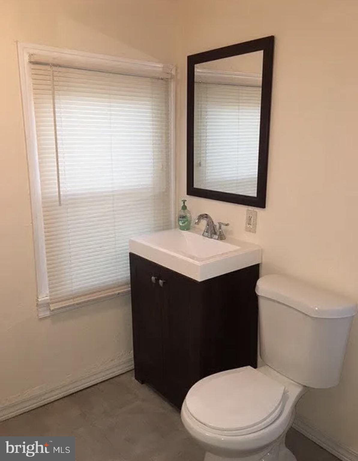 37 Olive Street Salem, NJ 08079 - Photo 16 of 19 a bathroom with a sink vanity mirror and toilet