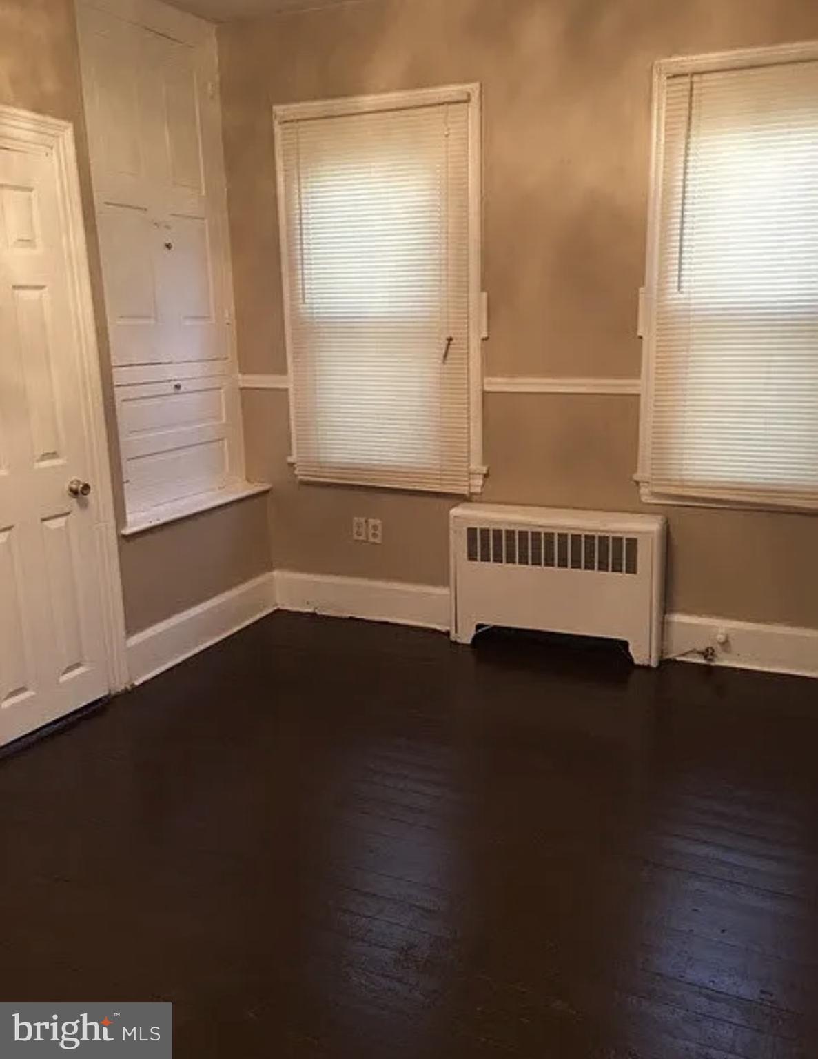 37 Olive Street Salem, NJ 08079 - Photo 8 of 19 an empty room with wooden floor and windows