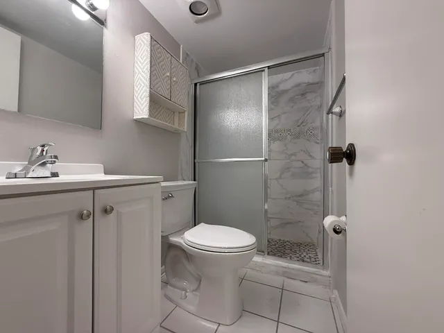 a bathroom with a sink toilet and shower