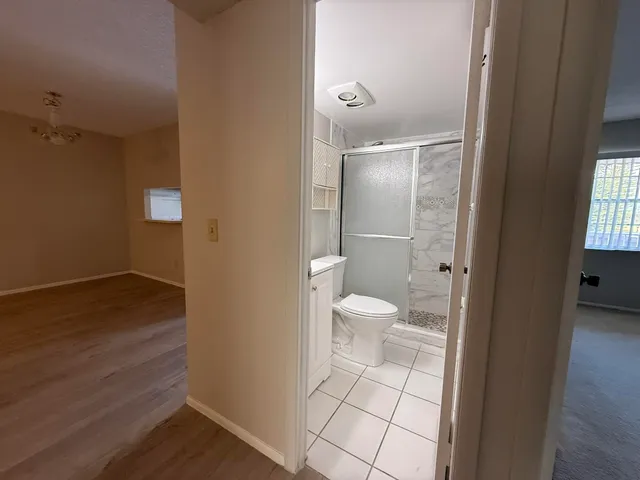a bathroom with a toilet and a mirror