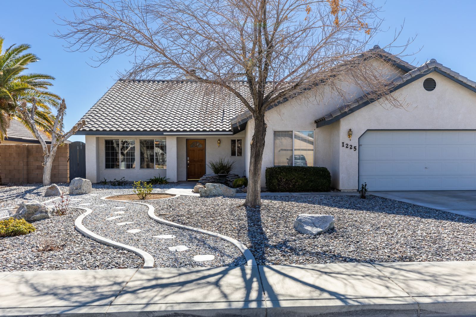 1225 Andrea Court Ridgecrest, CA 93555 - Photo 3 of 46 a front view of a house with garden