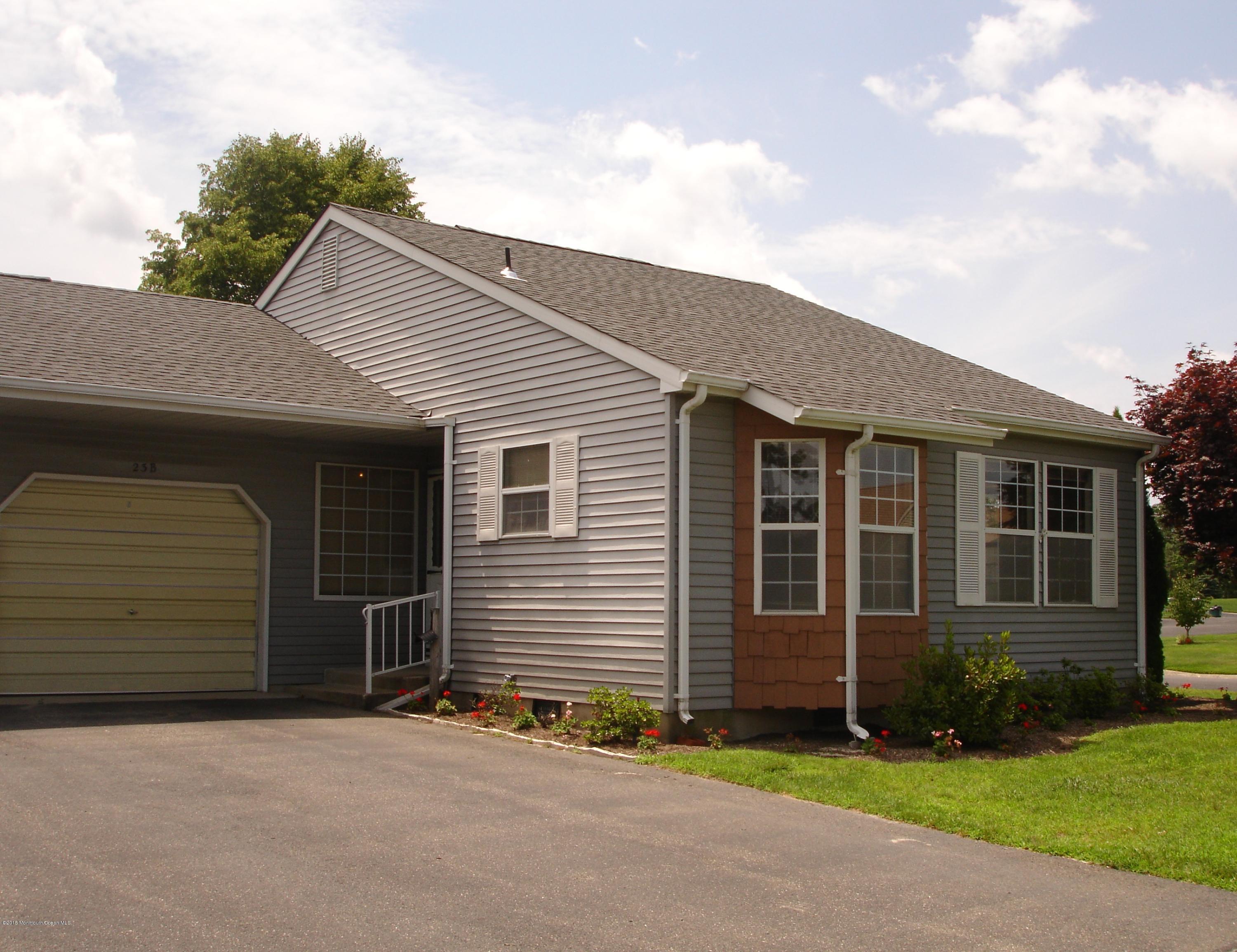 a front view of a house with a garden and garage