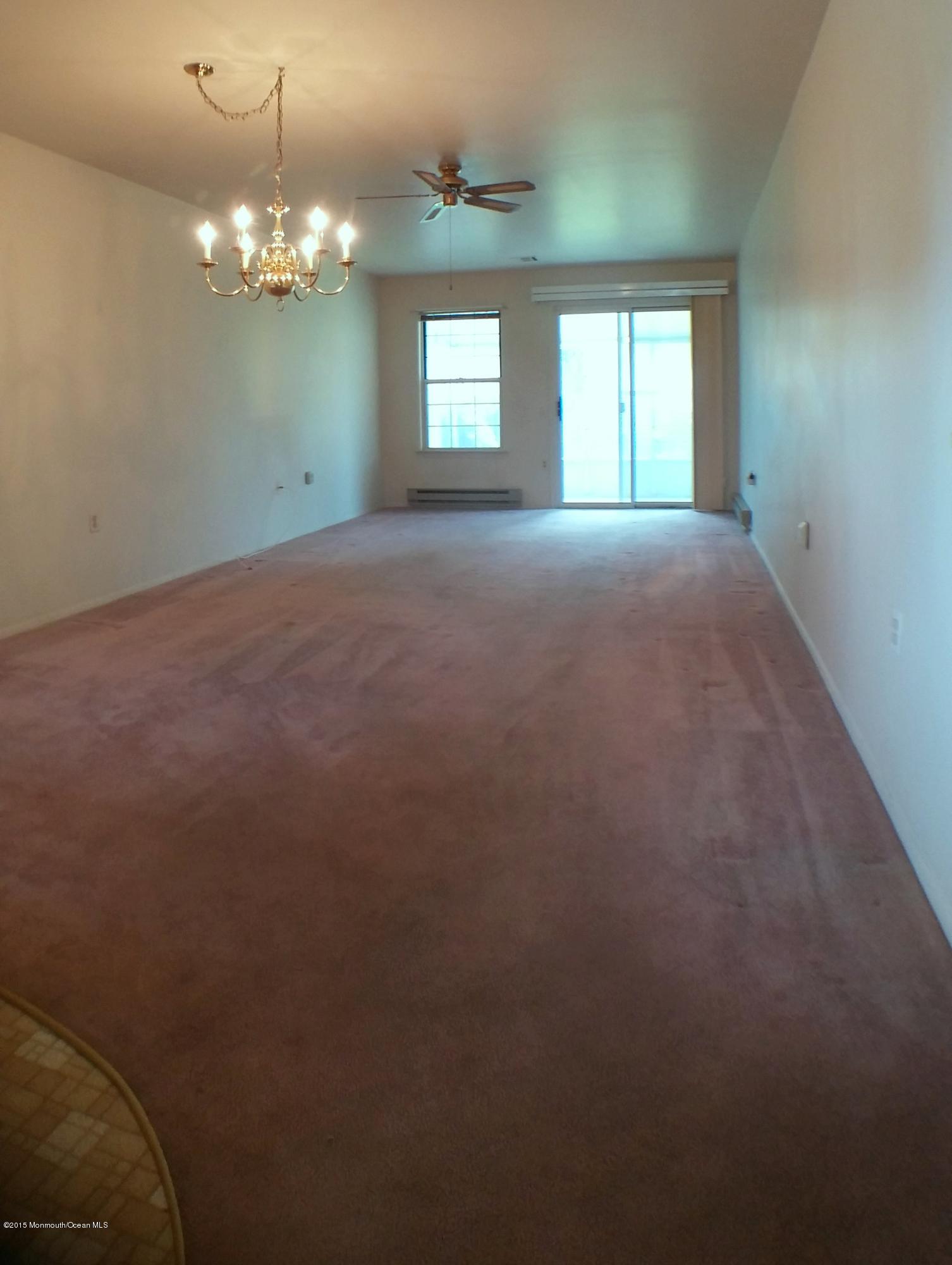 23B Mill Road, Unit B Whiting, NJ 08759 - Photo 12 of 22 a view of a chandelier and window in an empty room