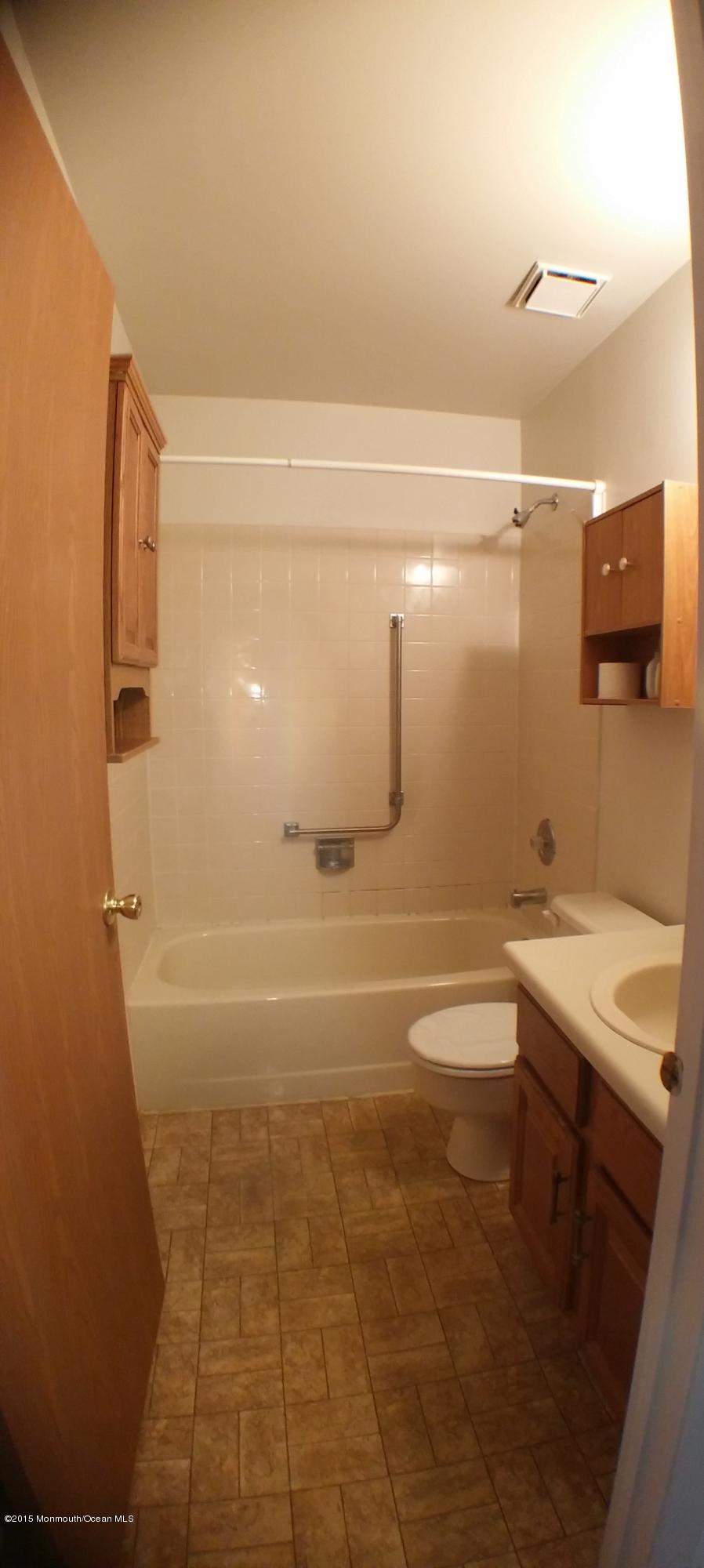 23B Mill Road, Unit B Whiting, NJ 08759 - Photo 20 of 22 a bathroom with a sink a toilet and mirror