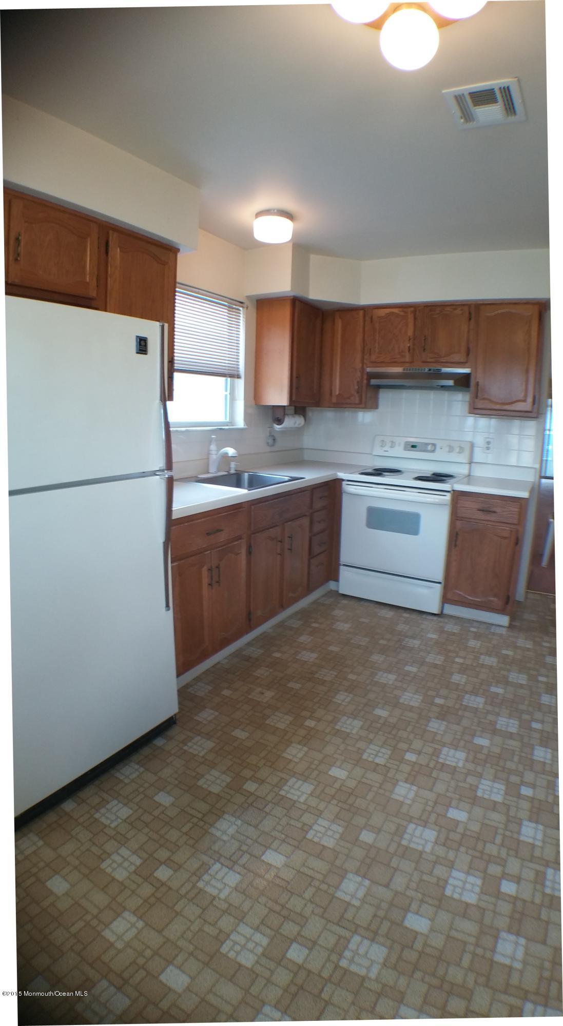 23B Mill Road, Unit B Whiting, NJ 08759 - Photo 7 of 22 a kitchen with granite countertop a refrigerator and a sink