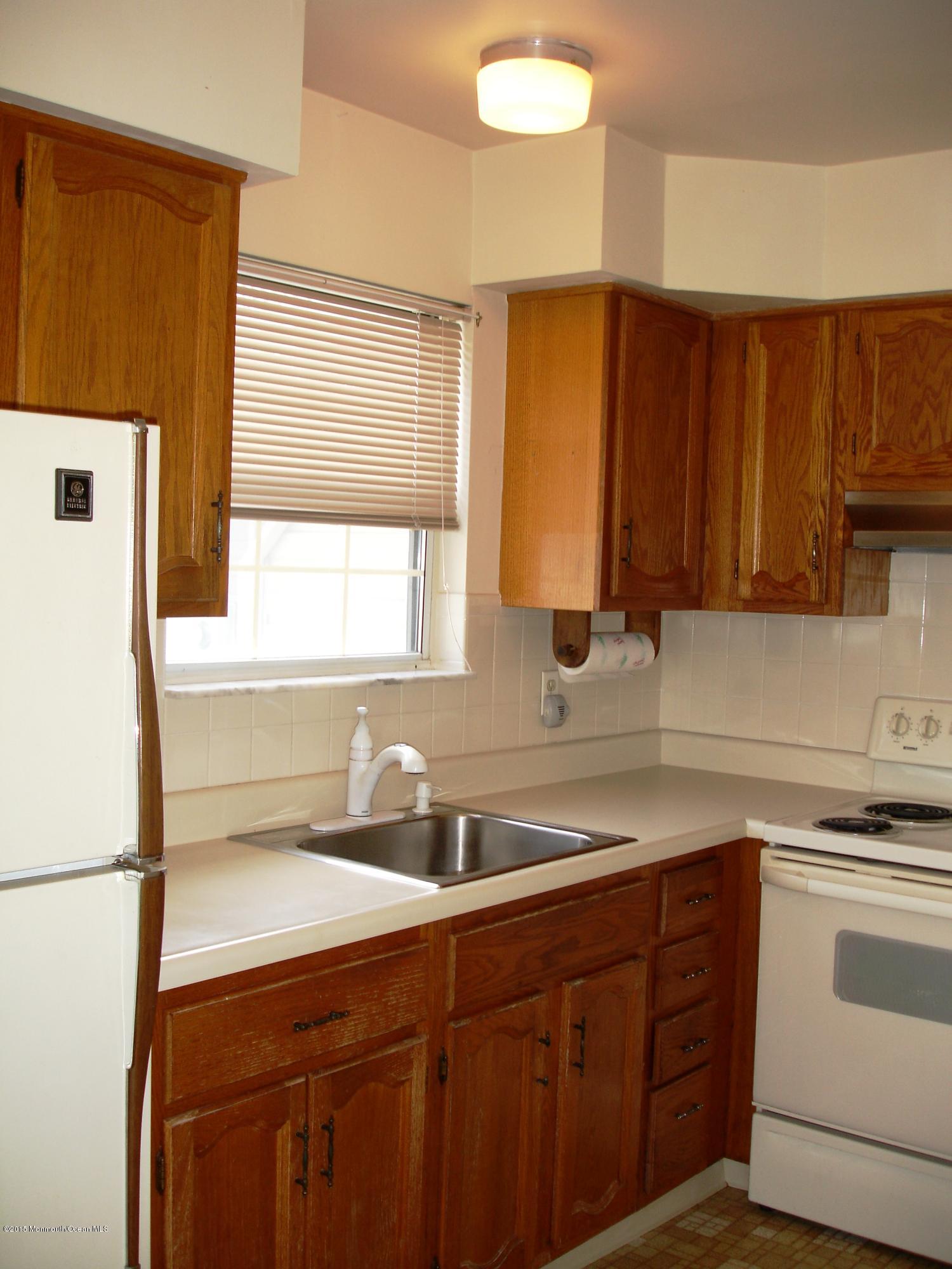23B Mill Road, Unit B Whiting, NJ 08759 - Photo 10 of 22 a kitchen with stainless steel appliances a refrigerator sink and cabinets