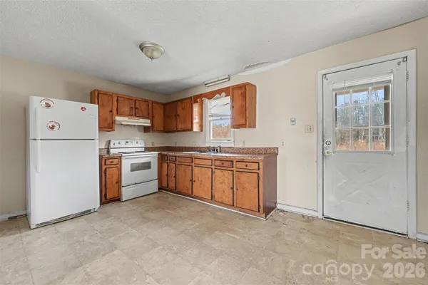 a kitchen with a cabinets and white appliances