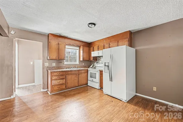 a kitchen with a refrigerator sink and stove