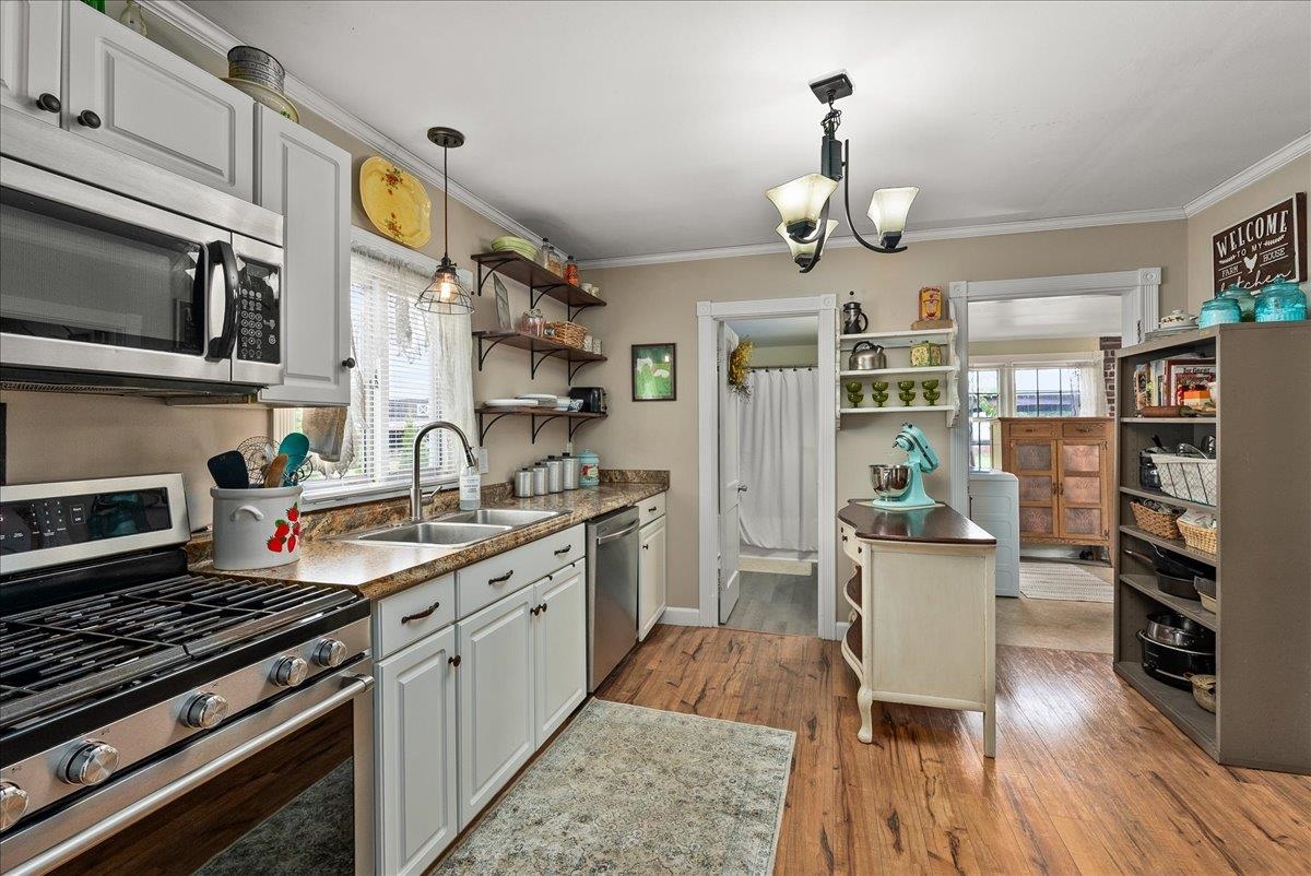 454 Dooms Crossing Road Waynesboro, VA 22980 - Photo 7 of 35 a kitchen with stainless steel appliances granite countertop a stove top oven a sink dishwasher and a dining table with wooden floor