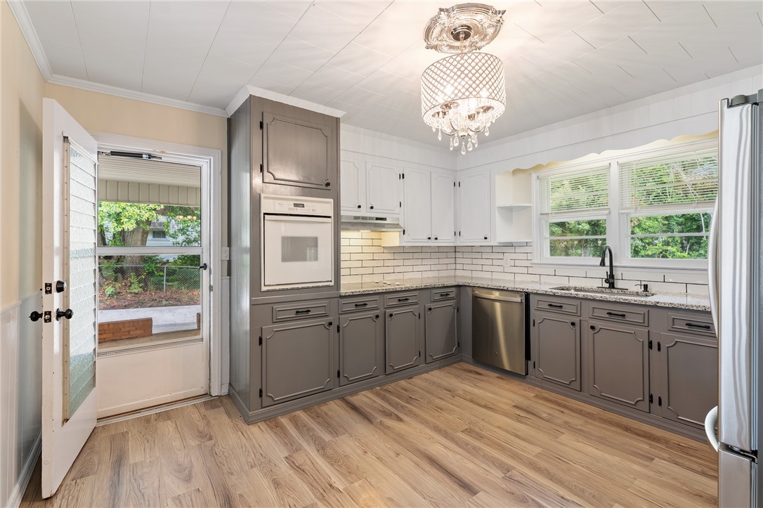 12 Dendy Street Pelzer, SC 29669 - Photo 8 of 31 A well-lit kitchen with modern appliances and ample counter space awaits culinary adventures.