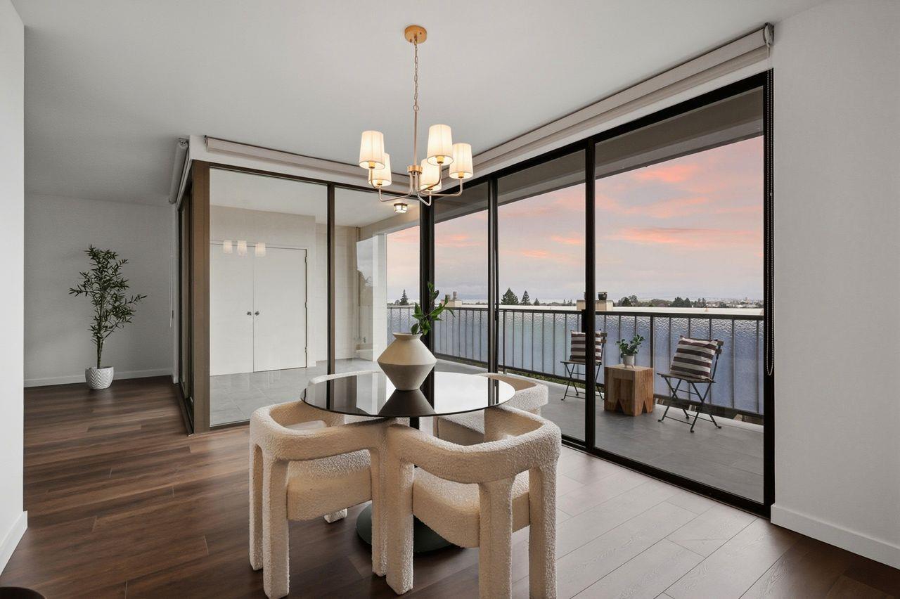 a view of a room with furniture large windows and wooden floor