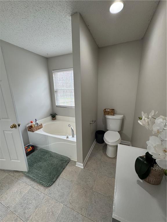 1003 Rolling Ridge Lane Auburn, GA 30011 - Photo 19 of 36 a bathroom with a bathtub sink and toilet