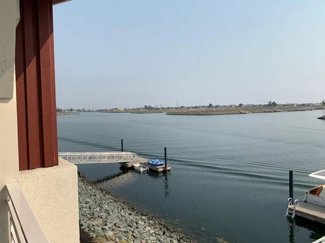 a view of a lake with couches chairs