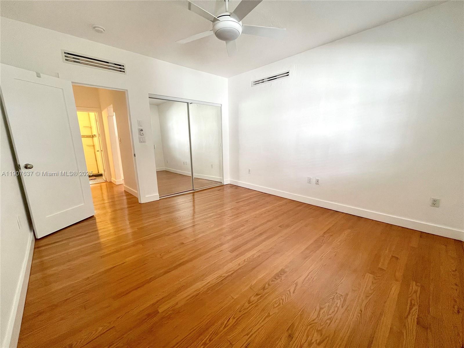1307 Euclid Avenue, Unit 2 Miami Beach, FL 33139 - Photo 12 of 13 a view of an empty room and wooden floor