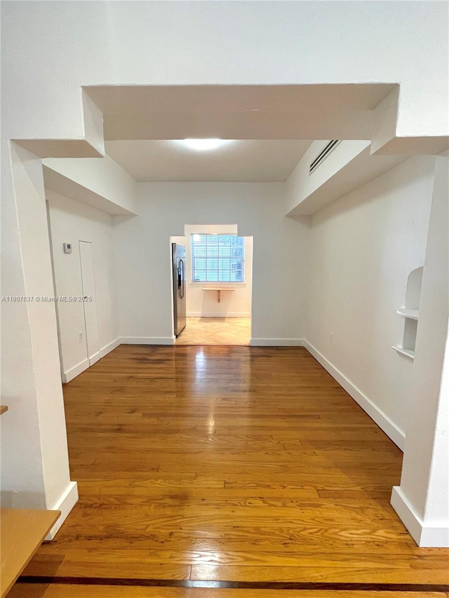 1307 Euclid Avenue, Unit 2 Miami Beach, FL 33139 - Photo 6 of 13 a view of empty room with wooden floor