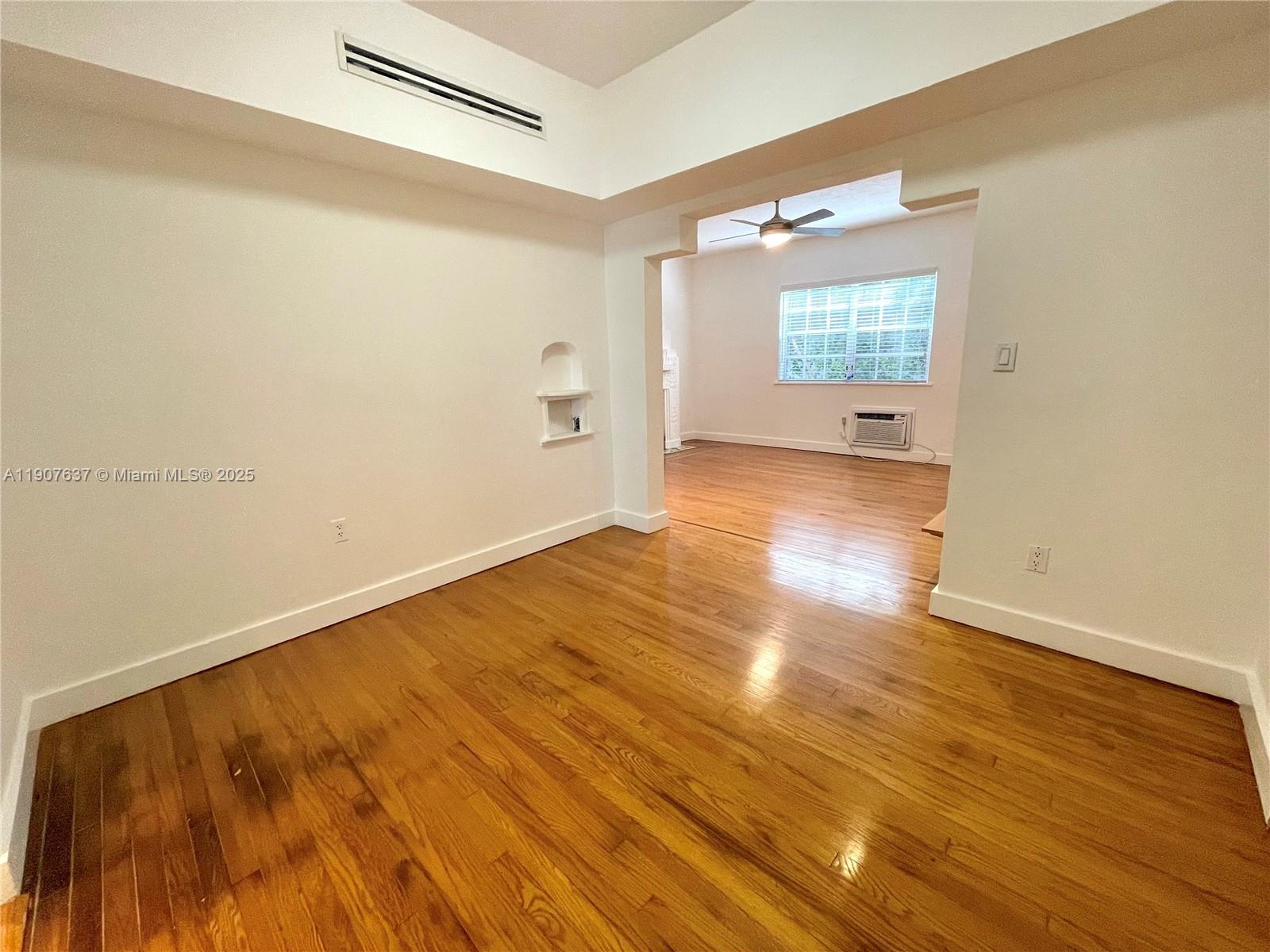 1307 Euclid Avenue, Unit 2 Miami Beach, FL 33139 - Photo 7 of 13 wooden floor in an empty room