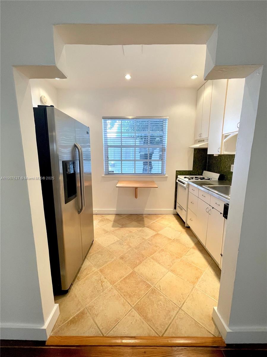 1307 Euclid Avenue, Unit 2 Miami Beach, FL 33139 - Photo 8 of 13 a view of a kitchen with fridge and wooden floor