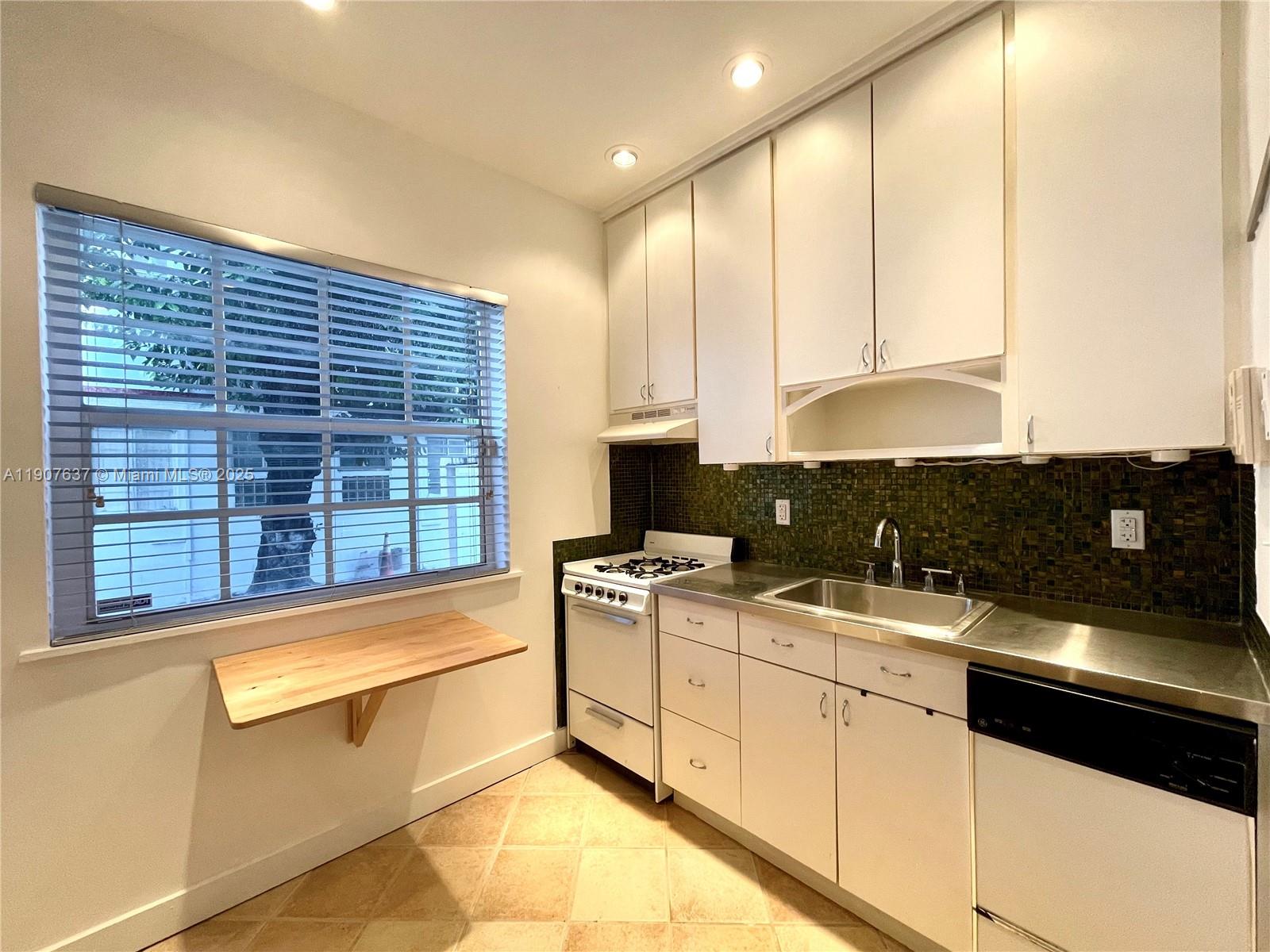 1307 Euclid Avenue, Unit 2 Miami Beach, FL 33139 - Photo 9 of 13 a kitchen with stainless steel appliances granite countertop a sink and cabinets