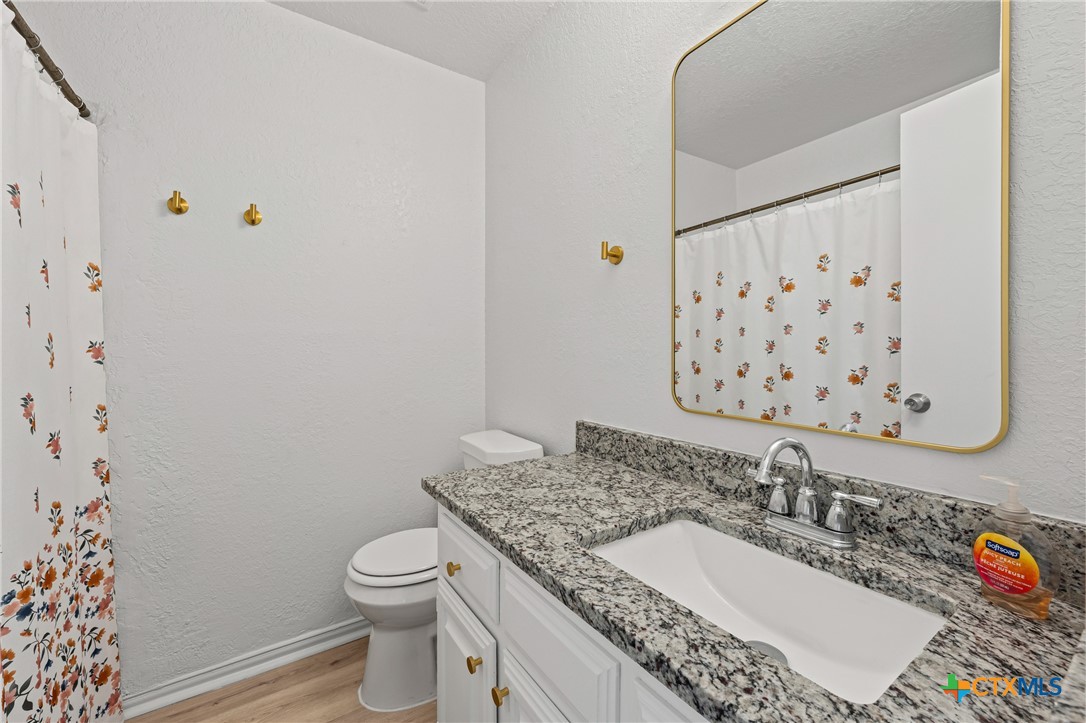 2313 Paul Revere Street, Unit A Temple, TX 76504 - Photo 13 of 22 a bathroom with a granite countertop sink and a mirror
