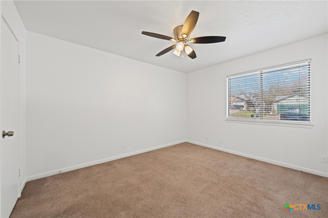 2313 Paul Revere Street, Unit A Temple, TX 76504 - Photo 15 of 22 an empty room with windows and fan