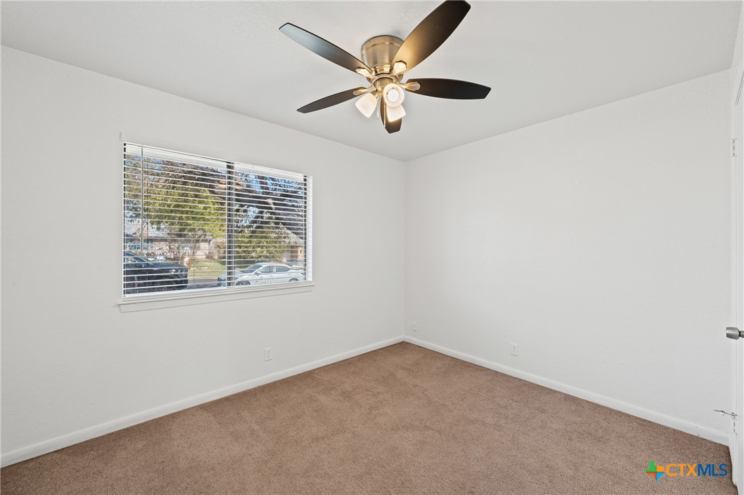 2313 Paul Revere Street, Unit A Temple, TX 76504 - Photo 18 of 22 an empty room with a window and a ceiling fan