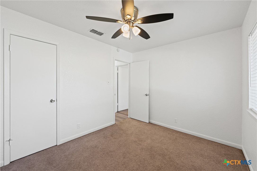 2313 Paul Revere Street, Unit A Temple, TX 76504 - Photo 19 of 22 an empty room with a window and a fan