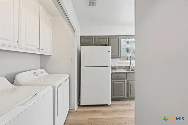 a kitchen with a sink stove and refrigerator