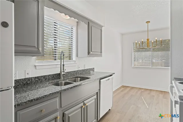 a kitchen with a refrigerator and a sink
