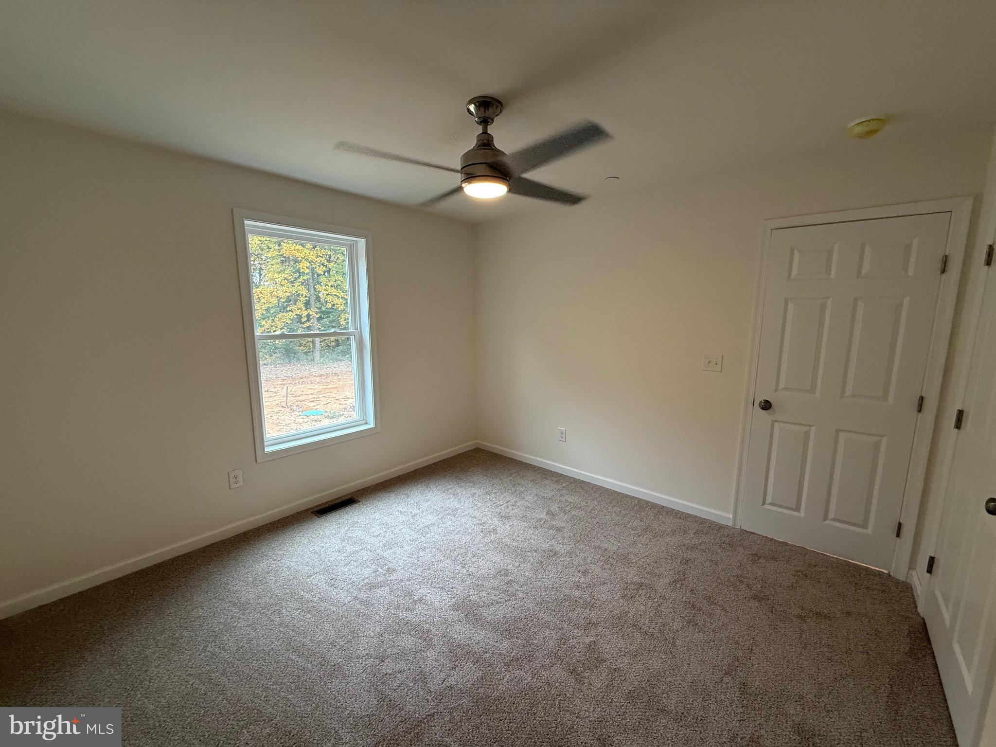 26994 Branchtown Road Worton, MD 21678 - Photo 13 of 24 an empty room with ceiling fan and window