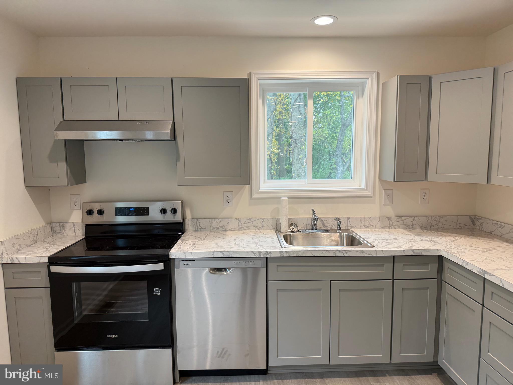 26994 Branchtown Road Worton, MD 21678 - Photo 6 of 24 a kitchen with a sink stove and cabinets