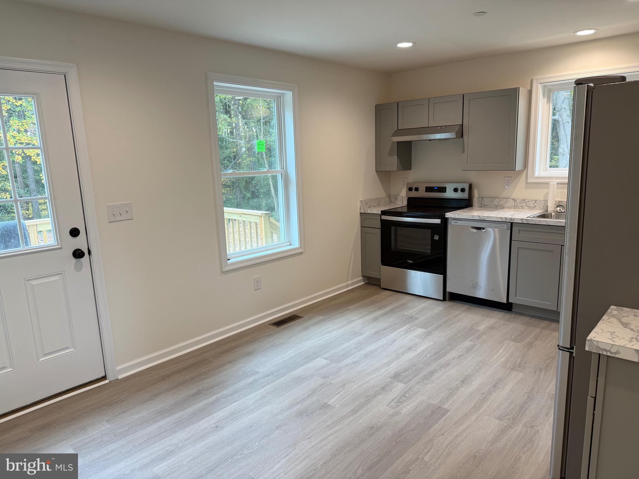 26994 Branchtown Road Worton, MD 21678 - Photo 7 of 24 a kitchen with a refrigerator and a stove top oven
