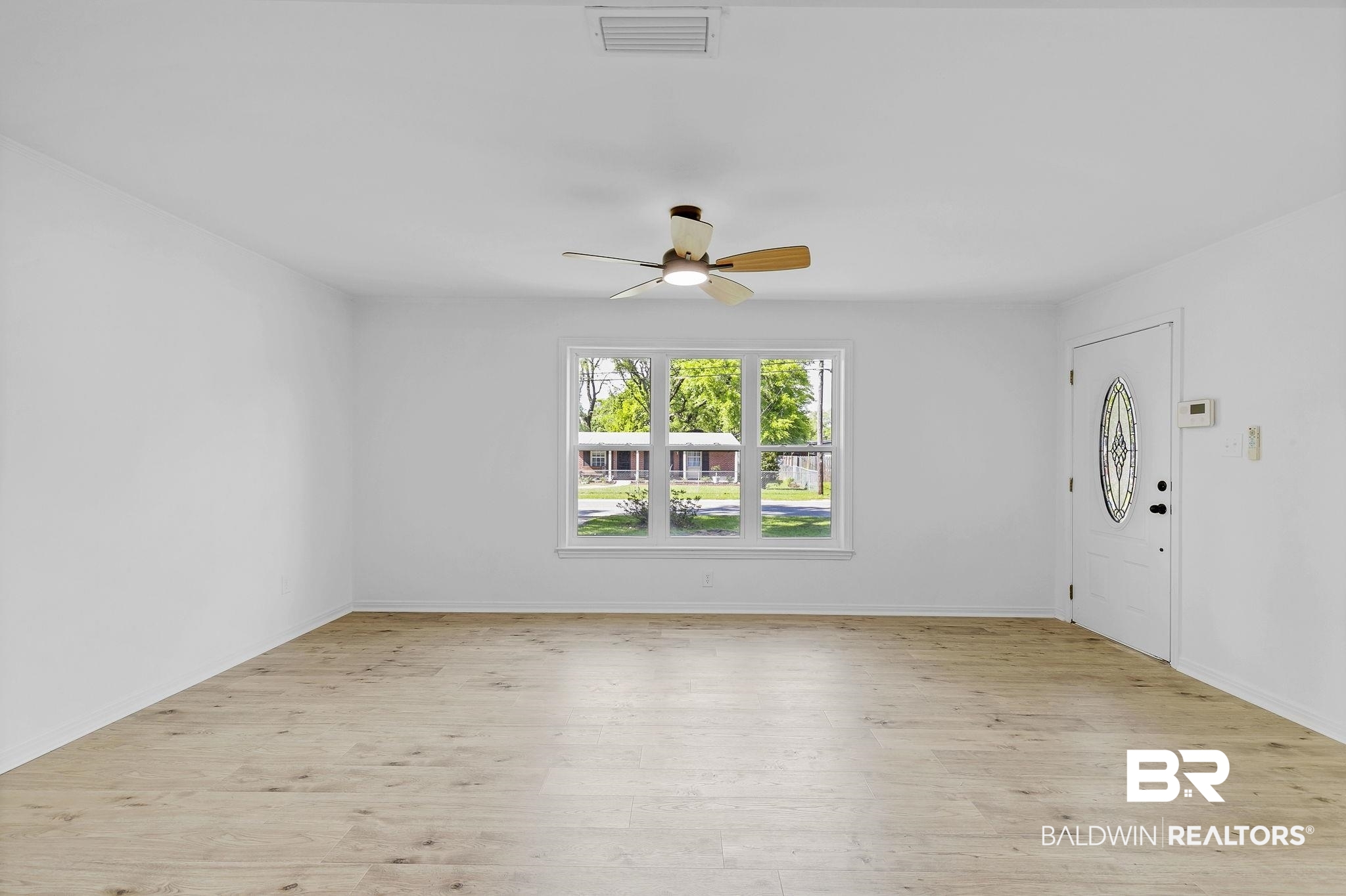 203 Anderson Road Saraland, AL 36571 - Photo 7 of 48 Interior space with light wood-style floors, visible vents, baseboards, and ceiling fan