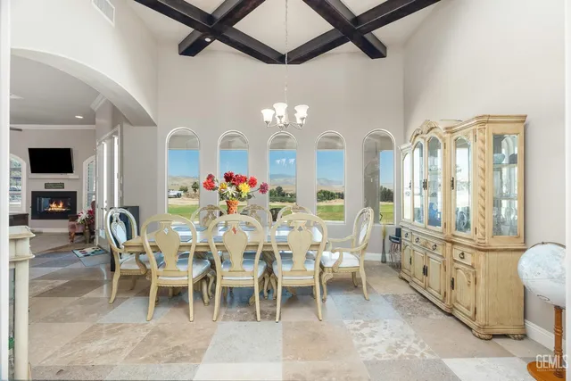 a view of a dining room with furniture and chandelier