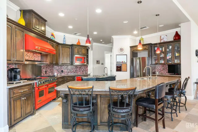 a kitchen with stainless steel appliances granite countertop a stove and a sink